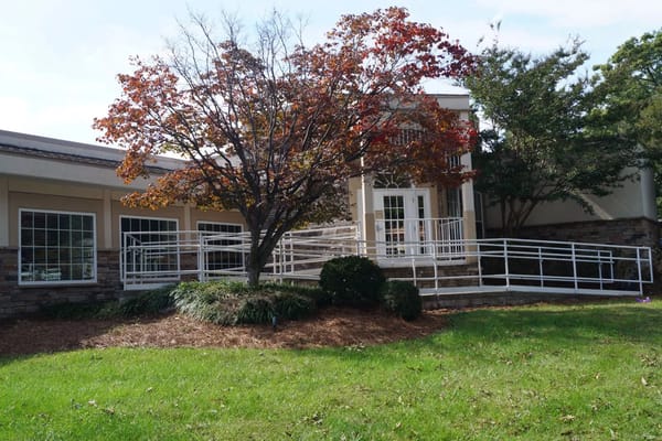 Exterior view of a senior living facility with landscaping