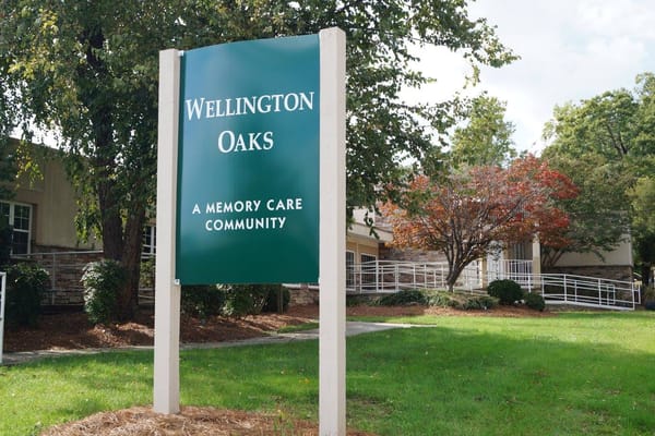 Sign for Wellington Oaks in a landscaped setting