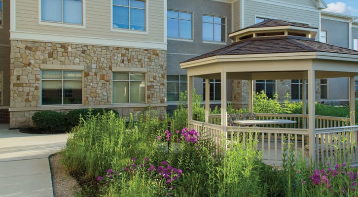 Outdoor gazebo surrounded by flowering plants