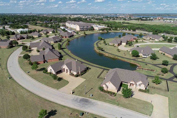 Aerial view of a senior living community with winding water features