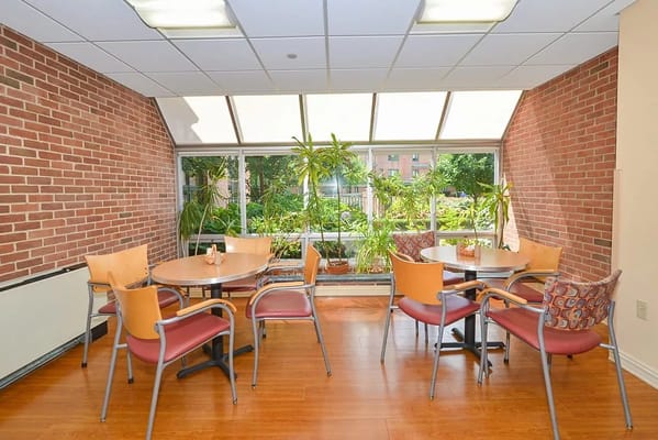Bright common area with tables and plants