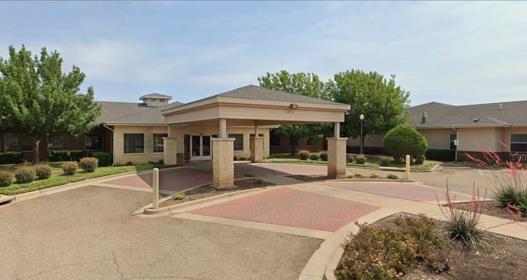 Exterior view of nursing home entrance with landscaping