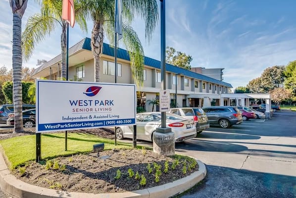 Exterior view of West Park Senior Living with parking area
