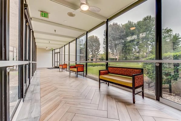 Bright corridor with seating and greenery outside