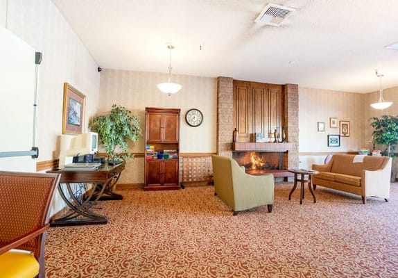 Interior view of a common area with seating and a fireplace