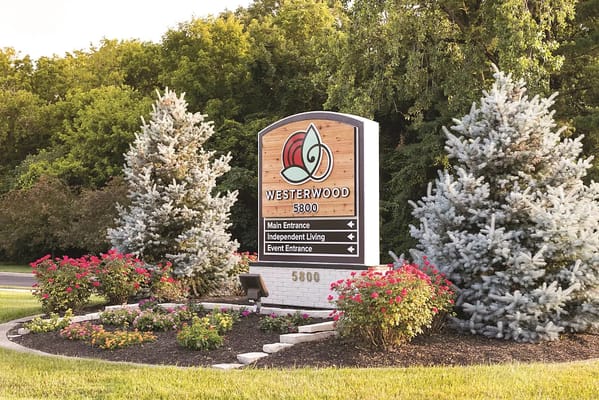 Signage for Westerwood senior living facility with directional arrows.