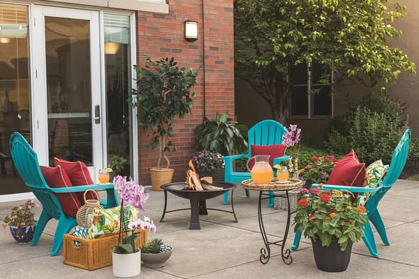 Colorful outdoor seating with flowers and refreshments