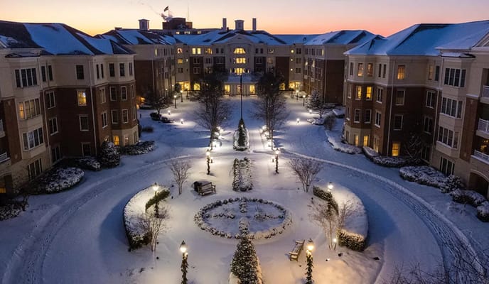 Snow-covered courtyard with lights and landscaping