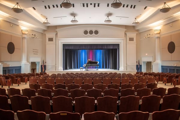 Interior view of an auditorium with empty seats and a stage