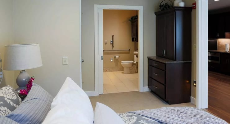 Interior view of a senior living bedroom with an ensuite bathroom