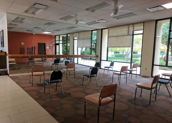 Interior common area with chairs arranged for social distancing