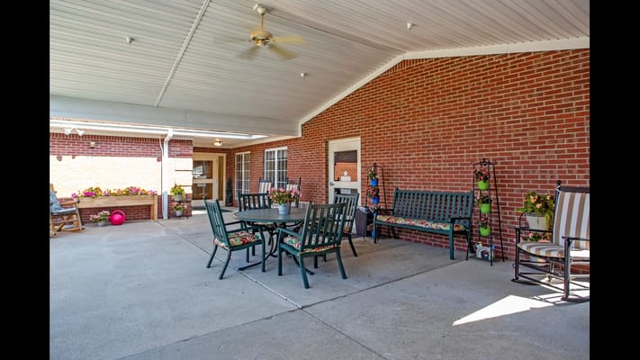 Seating area with tables and colorful flowers