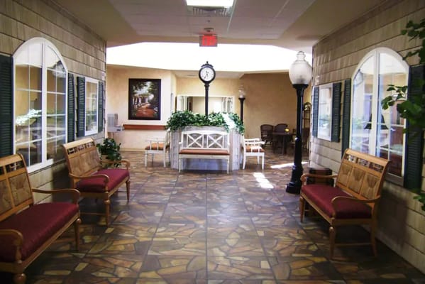 Well-lit hallway with benches and decorative elements