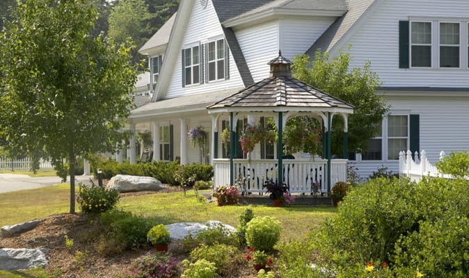 Exterior view of a senior living facility with a gazebo