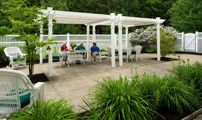 Residents enjoying time in an outdoor space with a gazebo