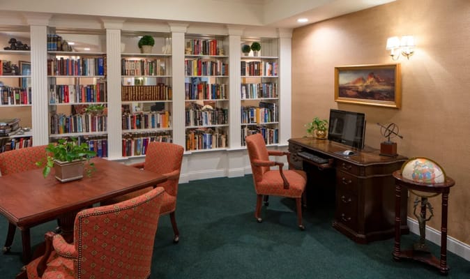 Cozy library area with bookshelves and computer