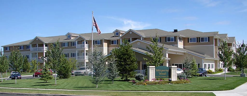 Exterior view of Whispering Winds facility with landscaping