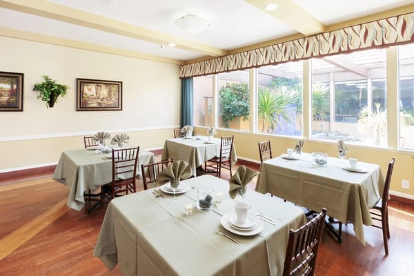 Dining area with neatly set tables and natural light