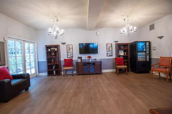 Bright common area with seating and entertainment center