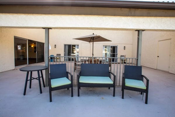 Outdoor seating area with chairs and an umbrella