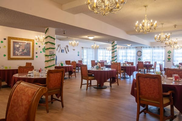 Dining room with tables set for residents