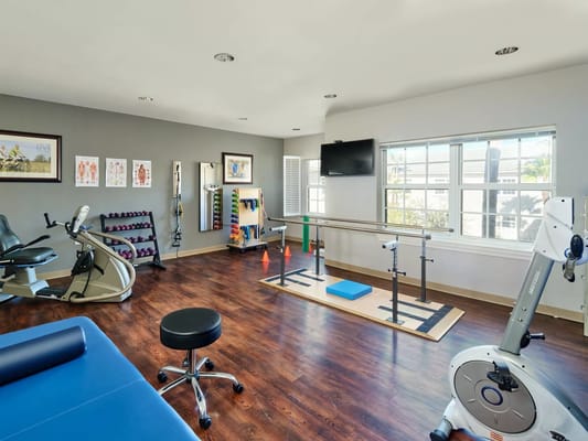 Well-equipped fitness room with exercise machines and weights