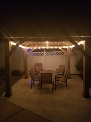 Outdoor seating area with lights under a gazebo