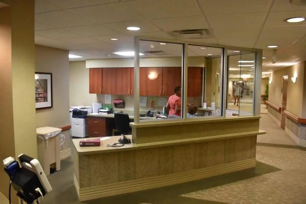 Reception area of a nursing home with staff member.