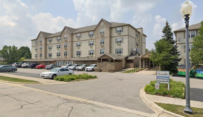 Front view of Willow Falls Senior Living facility with parking lot