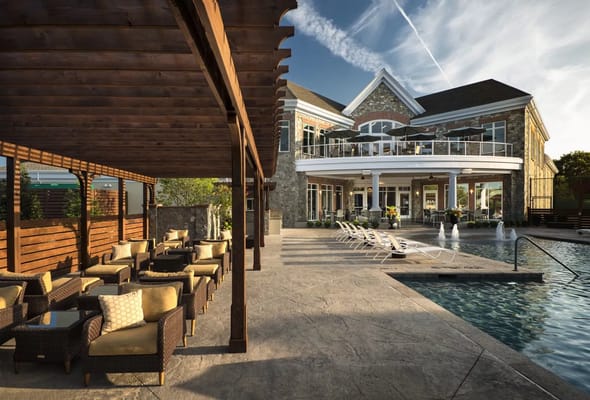 Outdoor pool area with seating and building facade