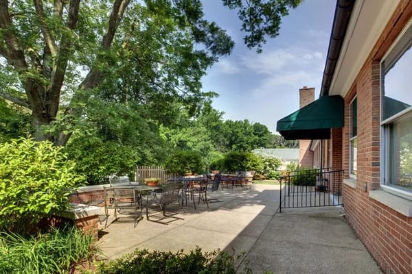 Outdoor patio area with seating and greenery