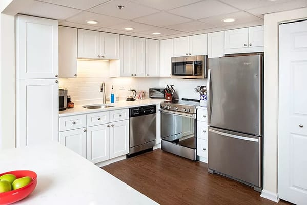 Modern kitchen with white cabinets and stainless steel appliances