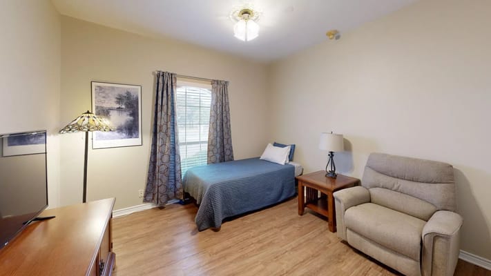 Private resident room with bed and seating area