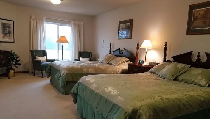 A cozy shared bedroom with twin beds and warm lighting