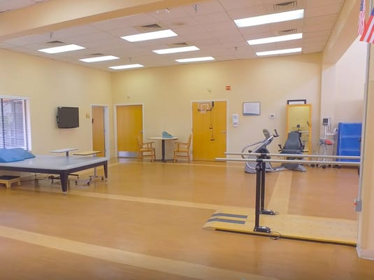 Physical therapy room with equipment in a senior care facility