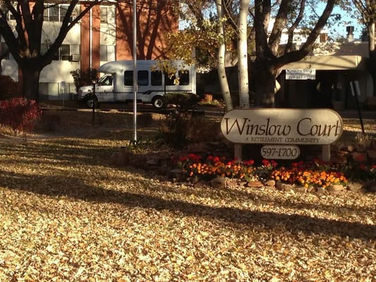 Sign of Winslow Court Retirement Community surrounded by autumn leaves