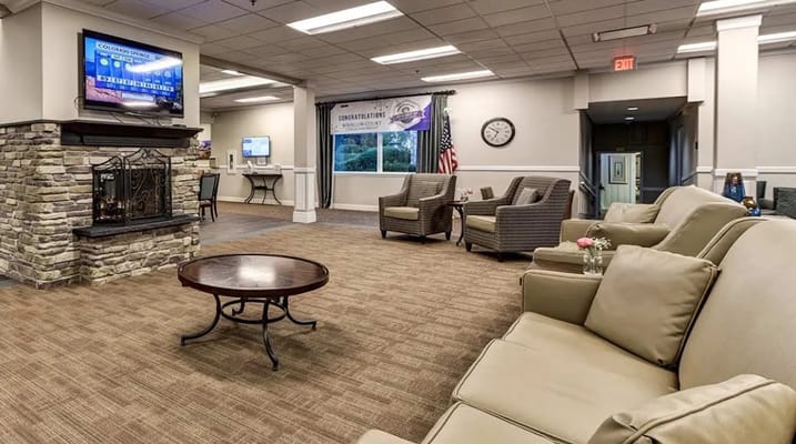 Lounge seating area with a fireplace and TV.