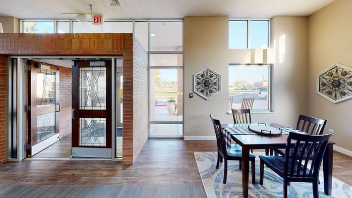 Bright interior common area with seating and large windows