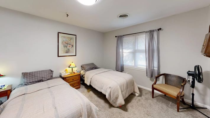 Cozy resident room with twin beds and window