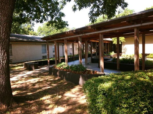 Entrance area with landscaping at Woodland Springs Nursing Center