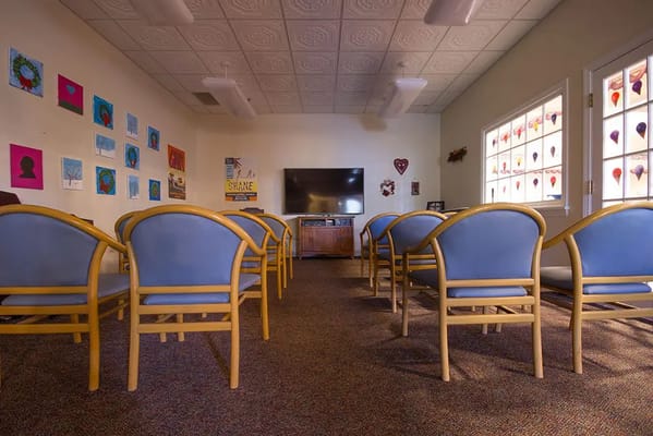 Interior view of a common area with chairs and artwork