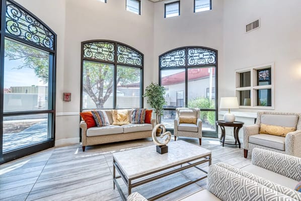 Bright common area with comfortable seating and large windows