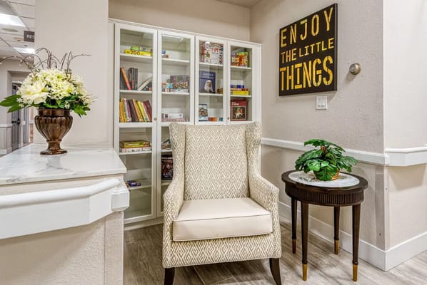 Cozy common area with a chair and bookshelf