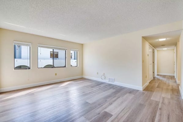 Bright living room with large windows in a senior living facility
