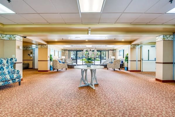 Spacious lobby with comfortable seating and a central table adorned with flowers.