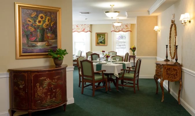 A beautifully set dining room with floral decor