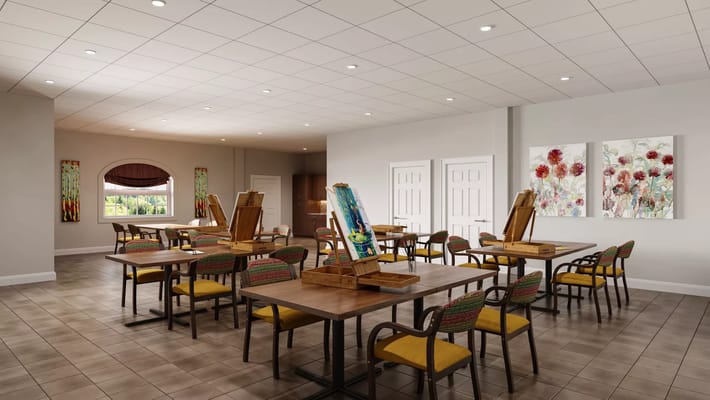 Interior of the art room featuring tables, easels, and artwork on the walls