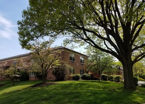 Exterior view of Wyomissing Rehabilitation and Nursing Center surrounded by greenery