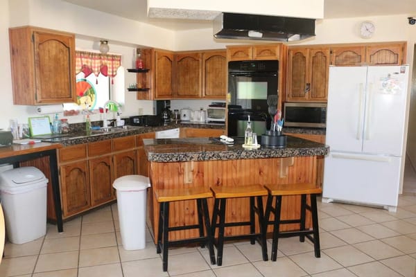 Modern kitchen with wooden cabinets and island seating