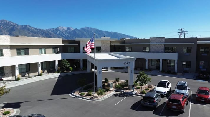 Front view of an assisted living facility with mountains